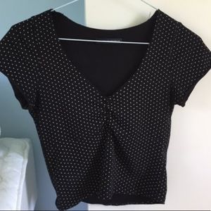 Black shirt with white polka dots.